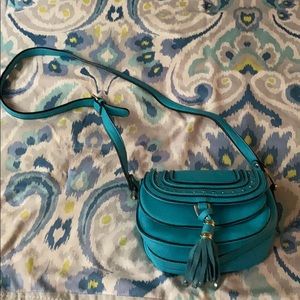 A blue over the shoulder purse